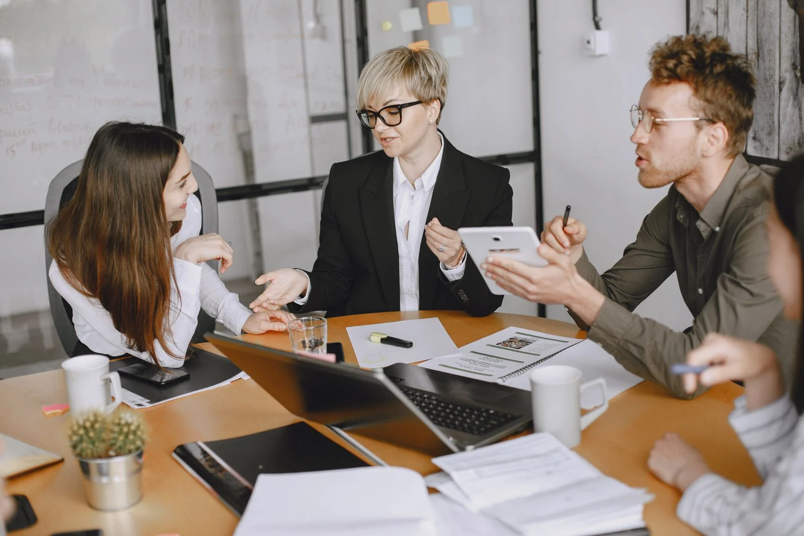 A group discussing documents around a meeting table